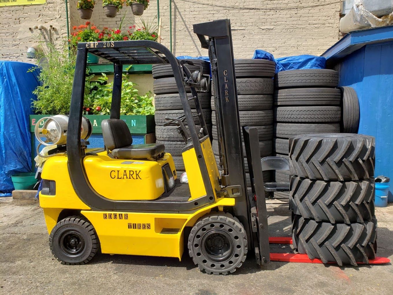 Forklift carrying industrial tires at the Paterson tire shop